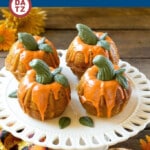 This pumpkin spice cake recipe is mini pumpkin flavored Bundt cakes that are topped with white chocolate ganache and fondant decorations to resemble actual pumpkins.