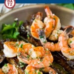 This surf and turf recipe features pan seared steaks and jumbo shrimp, all smothered in a garlic butter sauce.