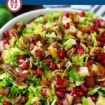This brussels sprout salad is made with shredded brussels sprouts, apples, pomegranate, bacon, pecan and feta cheese, all tossed in a sweet and savory dressing.
