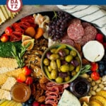 A complete guide on how to put together the best charcuterie board, with a selection of meats, cheeses, crackers, fruit, veggies and other snack foods.