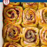 These hot ham and cheese pinwheels are rolls loaded with plenty of meat and swiss, then topped with a butter poppy seed sauce and baked to golden brown perfection.