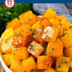 A bowl of roasted butternut squash on a table.