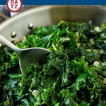 A pan of sauteed kale with a serving spoon.