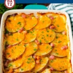 A baking dish with scalloped potatoes in ham with cheese melted across the top.