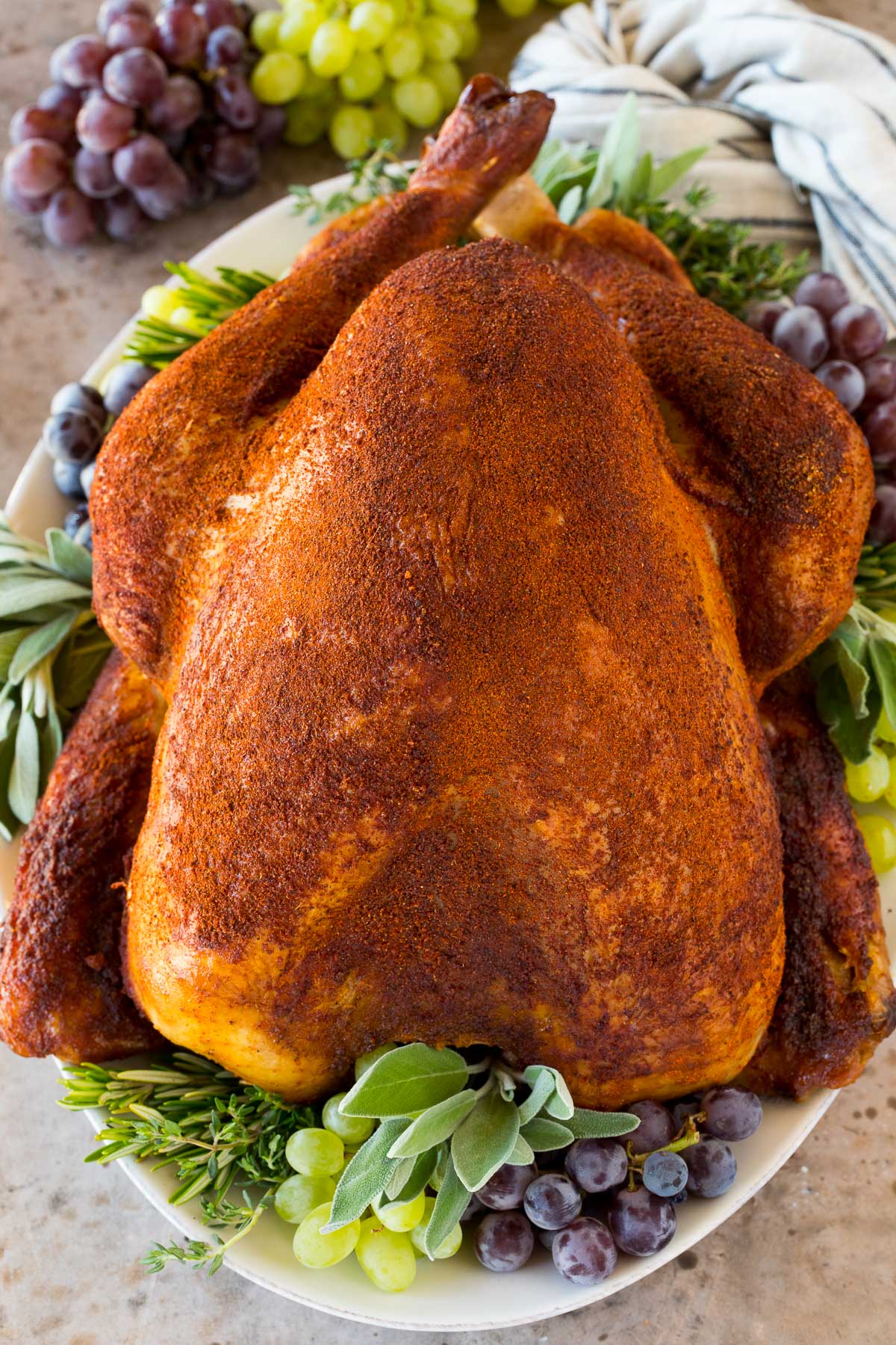 A cooked turkey coated in homemade smoked turkey rub.