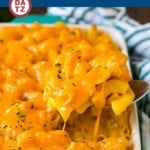 A dish of Southern mac and cheese being served with a spoon.