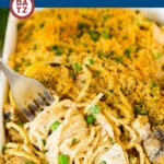 A baking dish with turkey tetrazzini and a few noodles on a fork.
