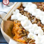 A sweet potato casserole with marshmallows in a a baking dish.