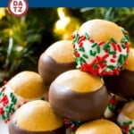 A plate of buckeye balls on a plate decorated with sprinkles.