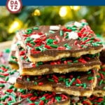 A stack of Christmas crack on a place with holiday sprinkles.