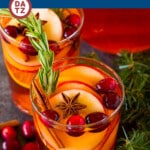 This Christmas sangria recipe is a blend of white wine, brandy, apple cider and holiday flavors including oranges, cinnamon and cranberries.