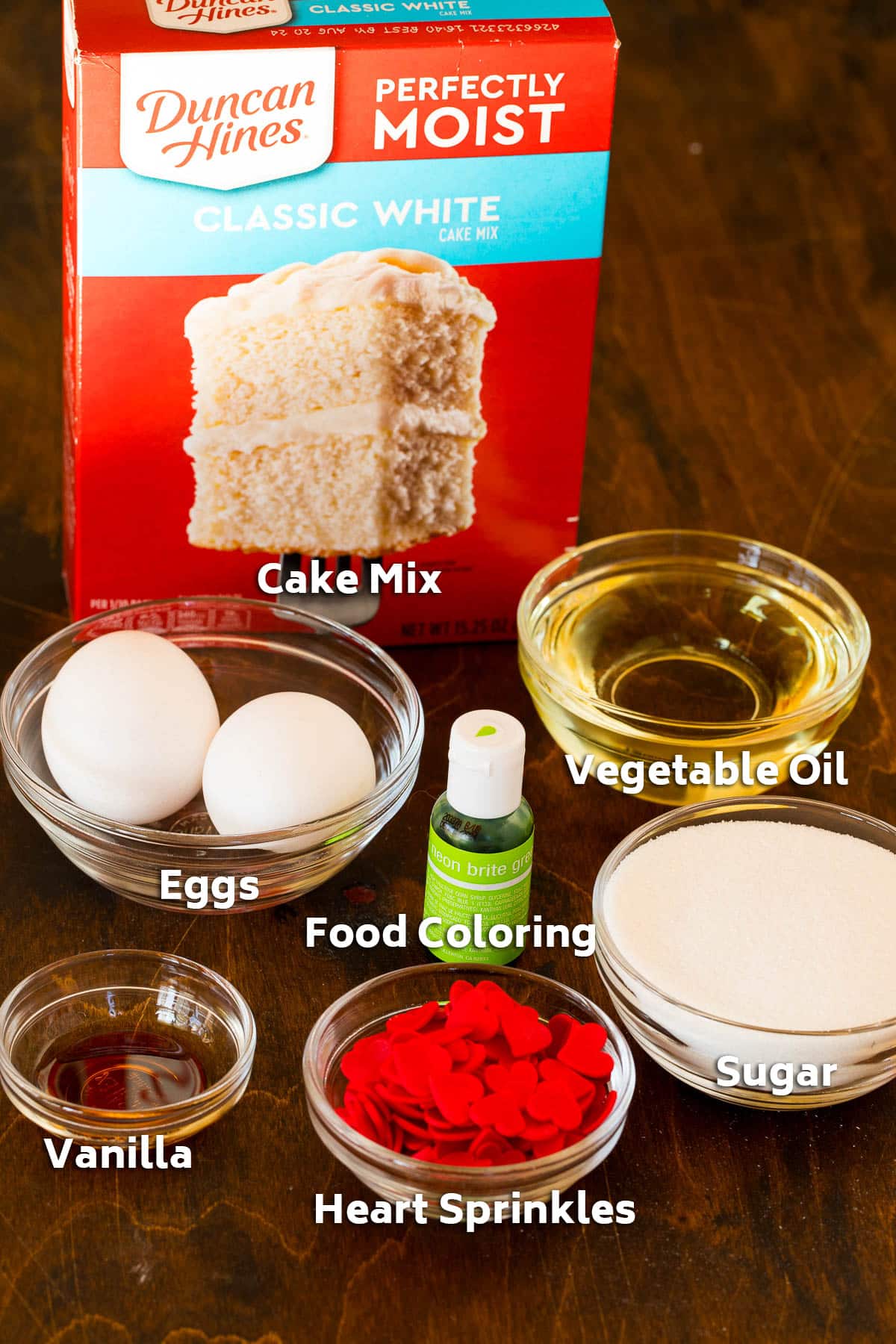 Ingredients including cake mix, oil, eggs, vanilla and food coloring.