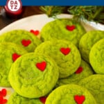 These Grinch cookies are soft and chewy cake mix cookies, rolled in sugar and topped with a red heart.