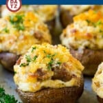 A tray of sausage stuffed mushrooms baked golden brown with cheese and breadcrumbs.