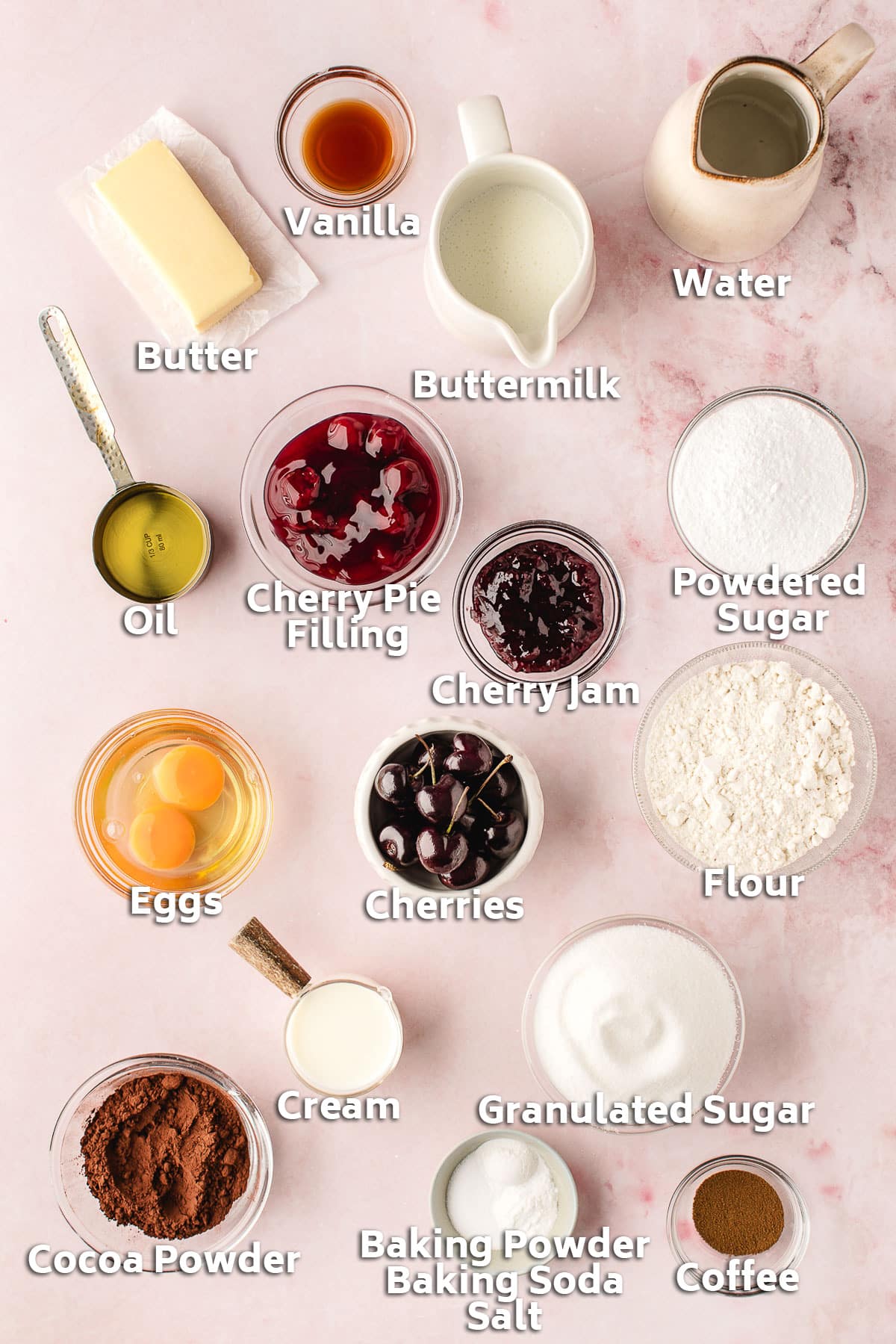 Bowls of ingredients including butter, flour, sugar, cocoa and cherry jam.