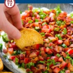 A dish of BLT dip with bacon, lettuce and tomatoes.