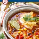 A pot of chicken taco soup with corn, beans and shredded chicken.