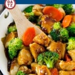 A pan of honey garlic chicken stir fry with chicken, honey garlic sauce, broccoli and carrots.