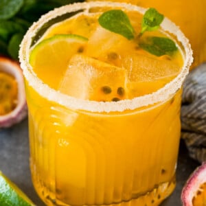 A passion fruit margarita topped with mint, lime and fresh passion fruit.