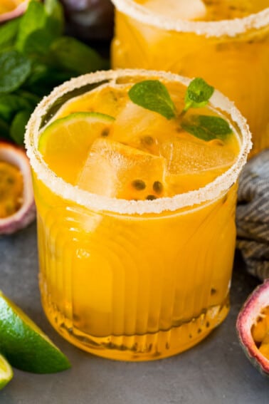 A passion fruit margarita topped with mint, lime and fresh passion fruit.