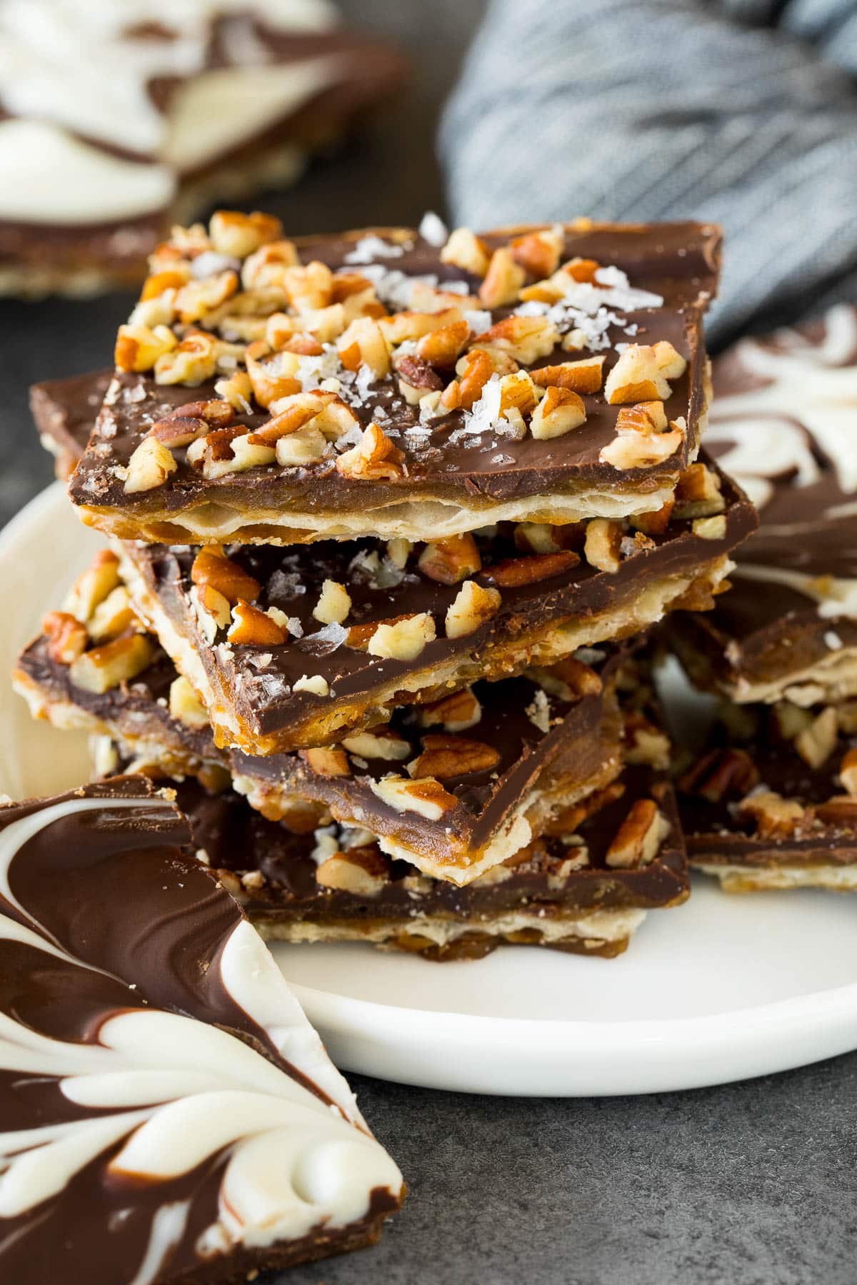 A stack of matzo crack squares topped with pecans and sea salt.