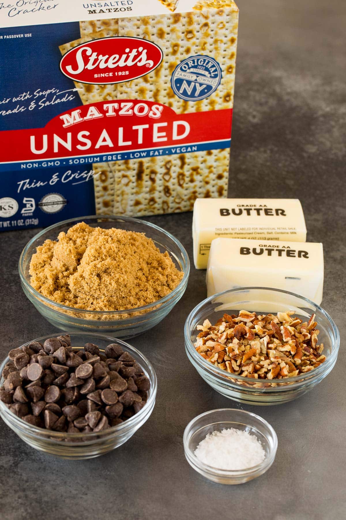 Ingredients including matzo, pecans, salt, chocolate, butter and brown sugar.