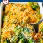 A dish of broccoli casserole with a cheesy sauce and crispy topping.