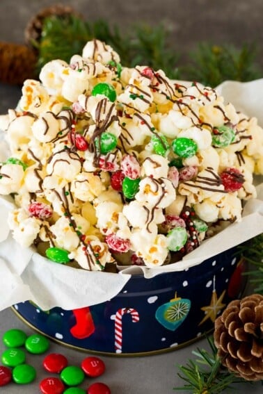 A gift tin filled with Christmas popcorn.