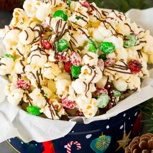 A gift tin filled with Christmas popcorn.