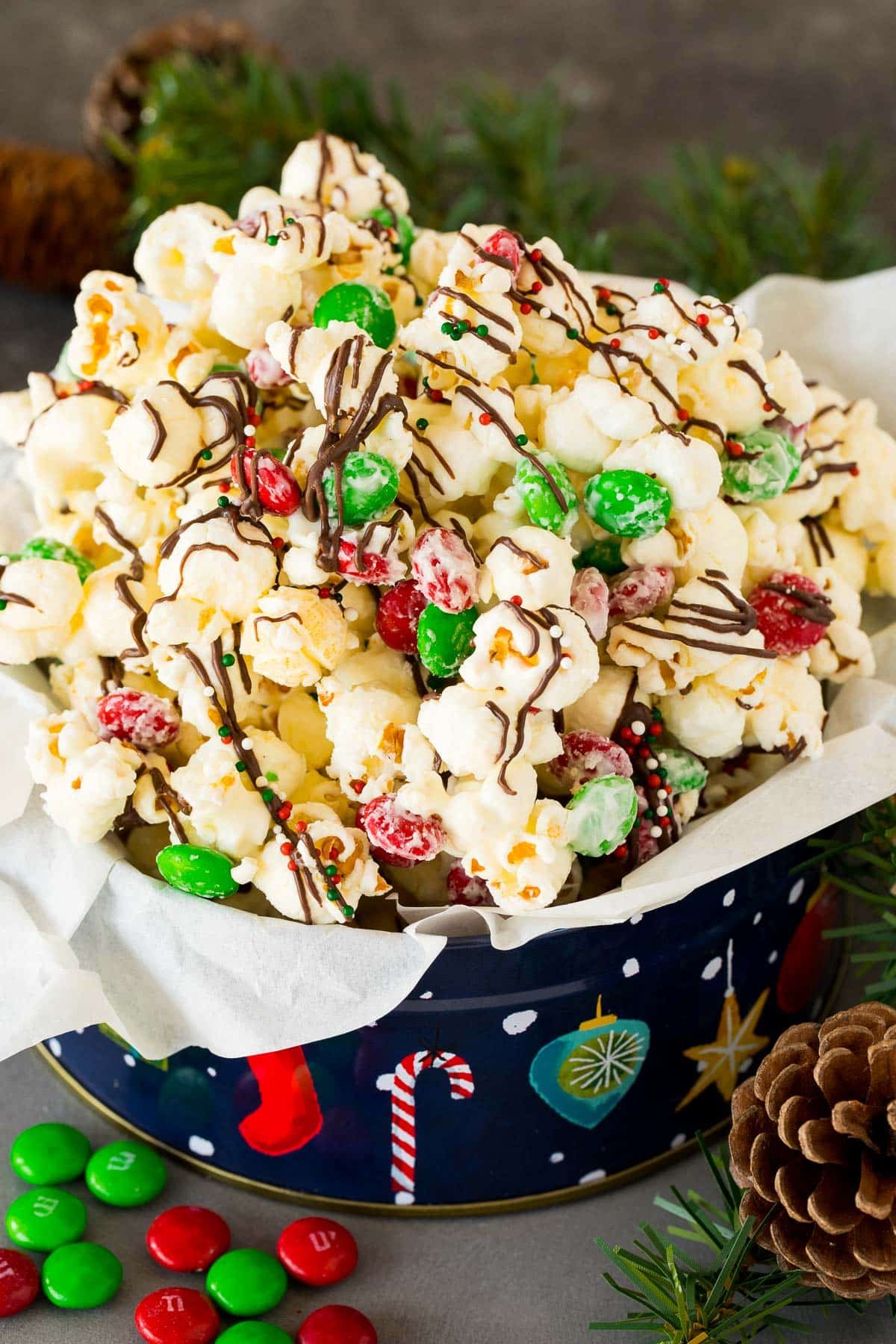 A gift tin filled with Christmas popcorn.