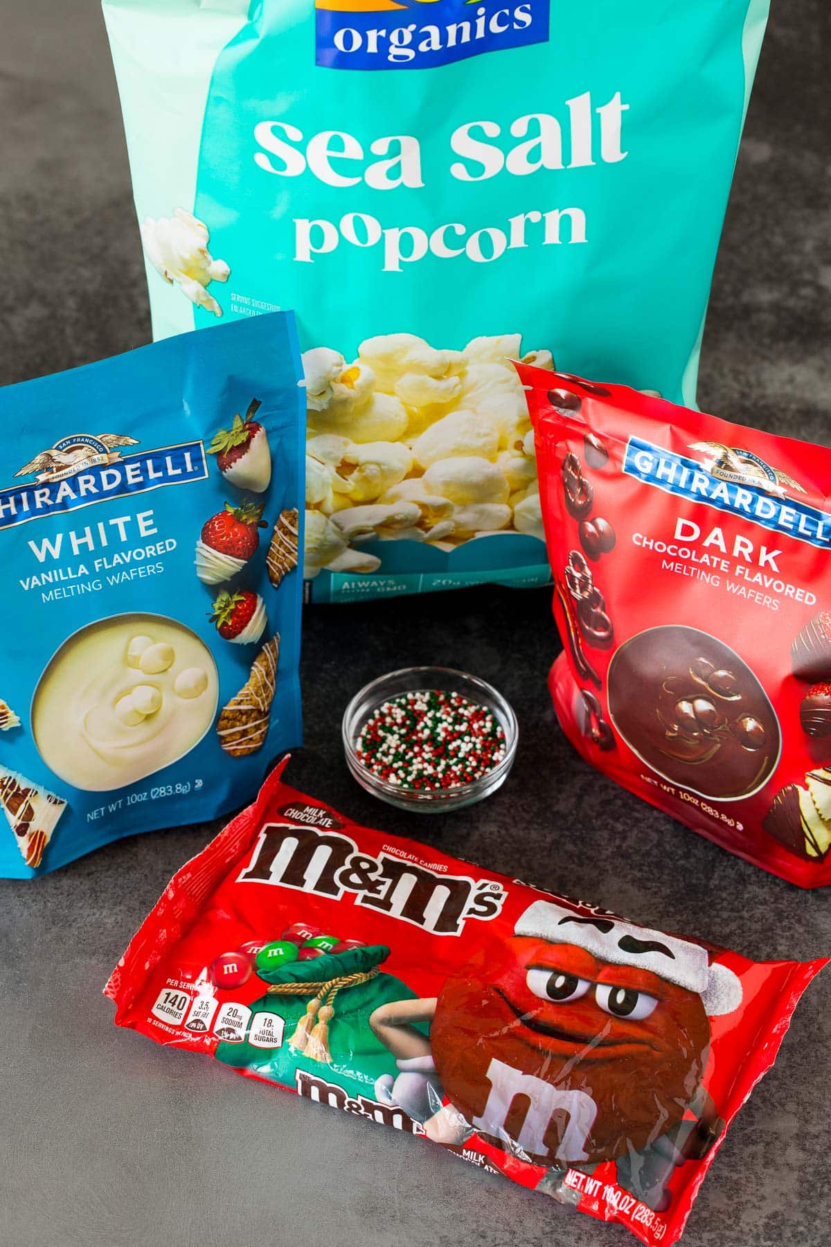 Ingredients including popcorn, candy melts, M&M's and sprinkles.