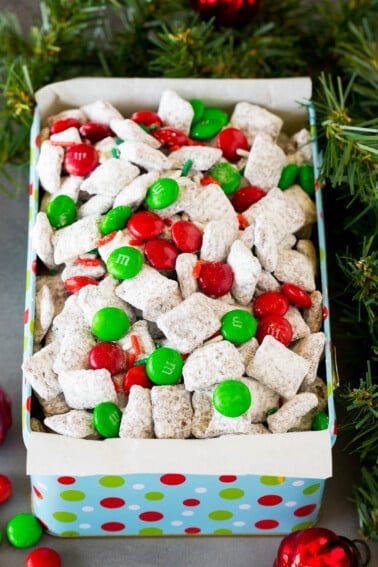 A holiday tin filled with Christmas puppy chow mix.
