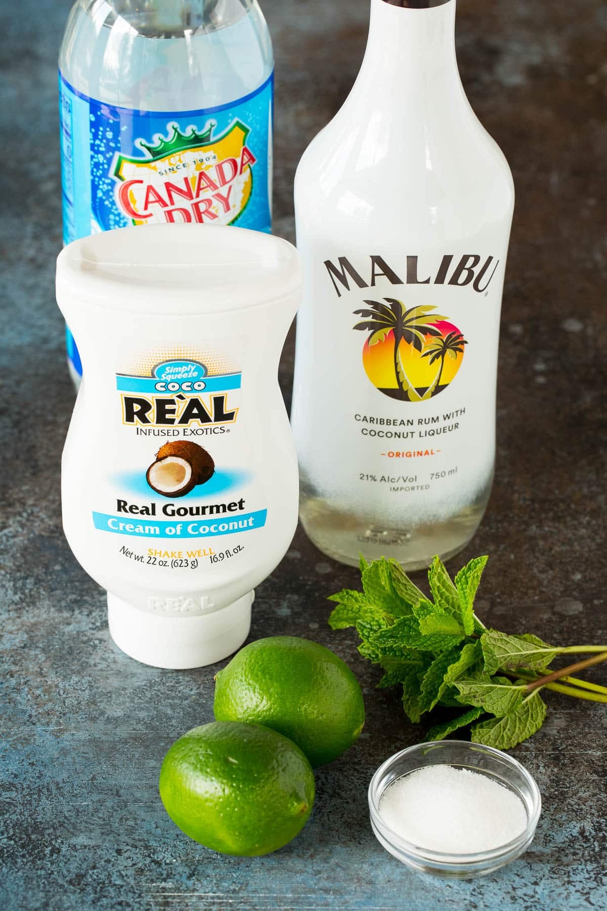 Ingredients including coconut rum, coconut cream, club soda, mint and limes.