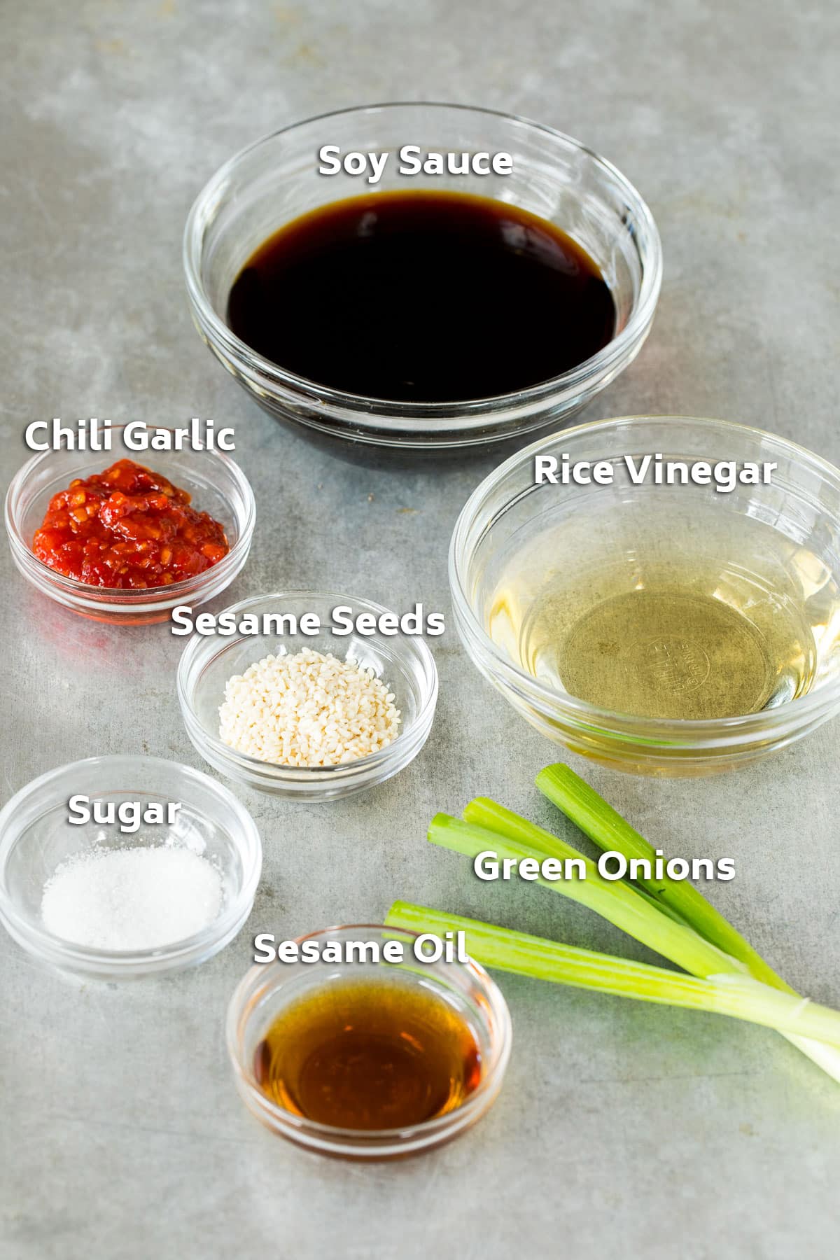 Ingredients including soy sauce, rice vinegar, chili garlic sauce and sugar.