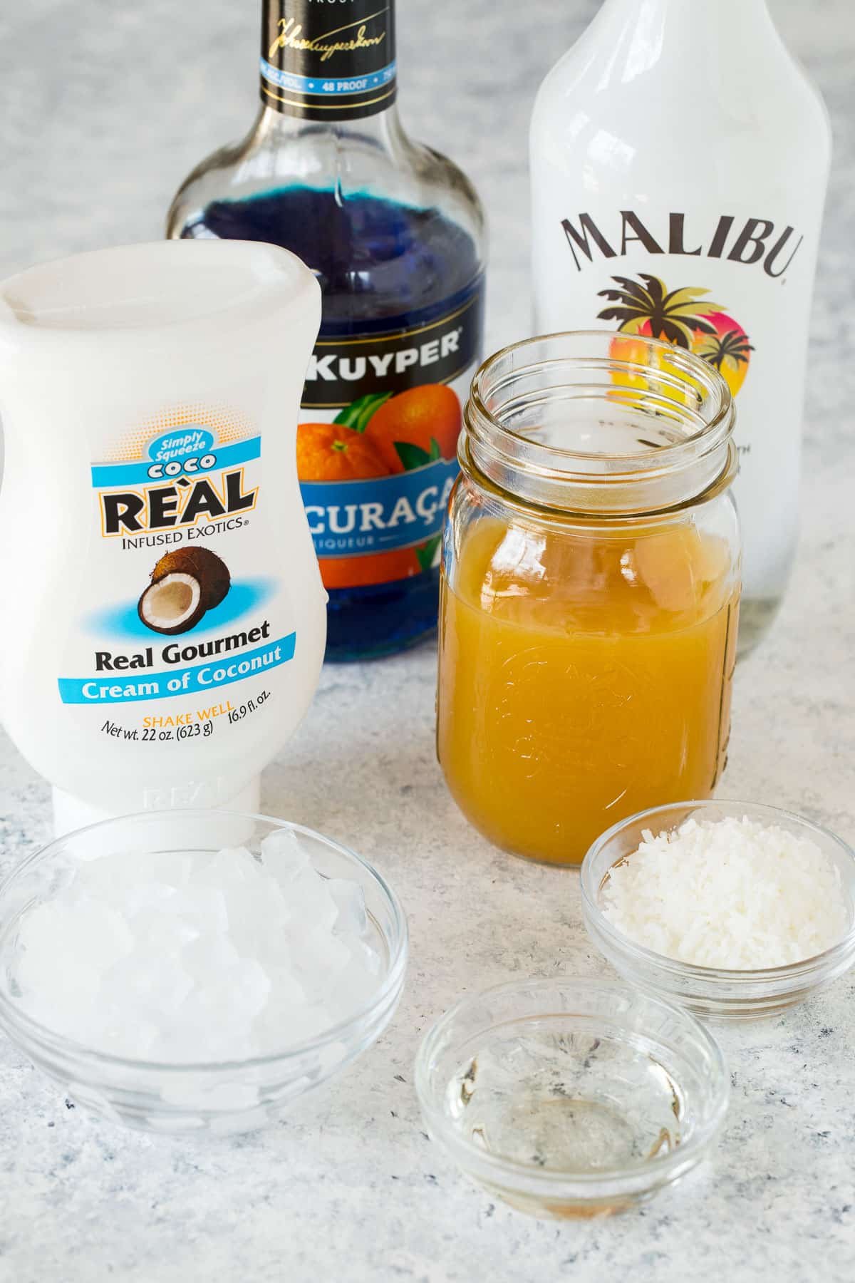 Ingredients including pineapple juice, coconut cream, coconut rum and blue curacao.