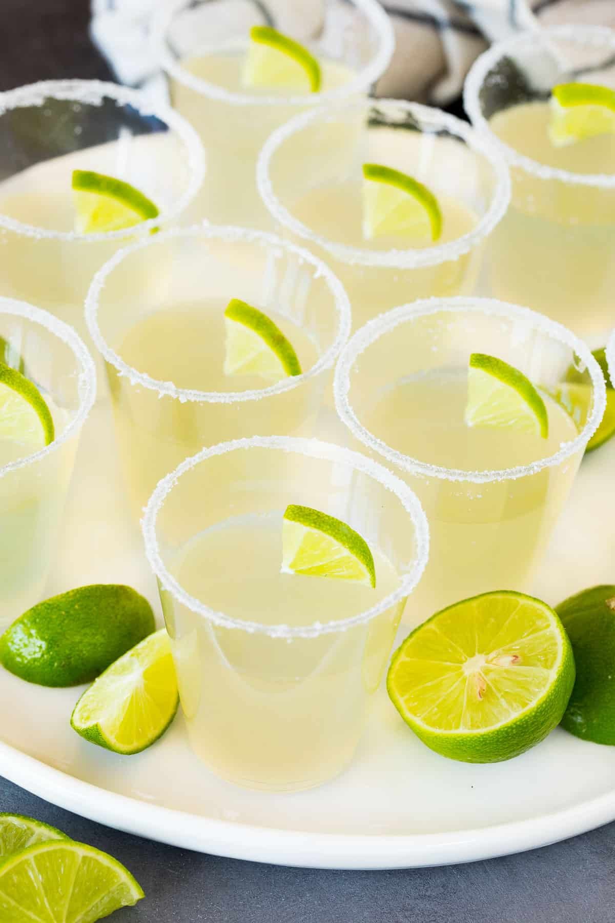 Margarita Jello shots on a plate garnished with limes.
