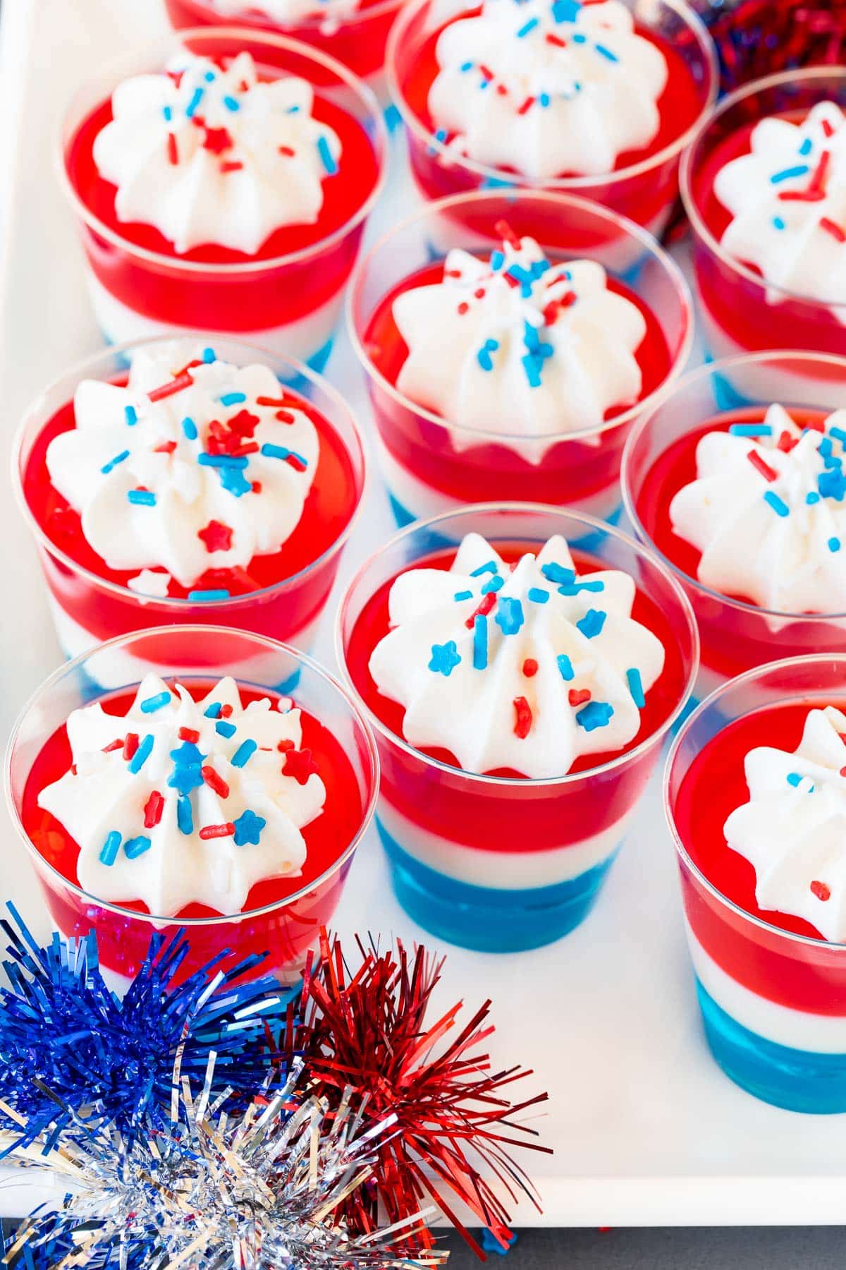 A serving plate filled with 4th of July Jello shots.