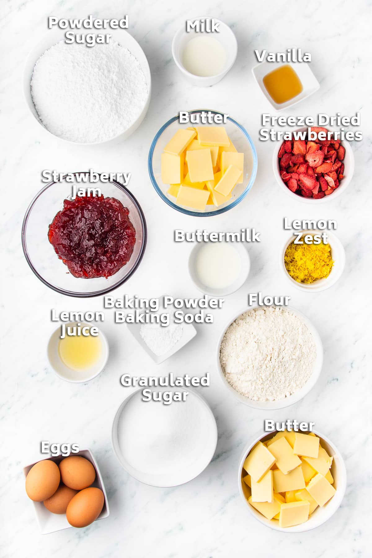 Bowls of ingredients including butter, flour, sugar, milk, eggs and strawberry jam.