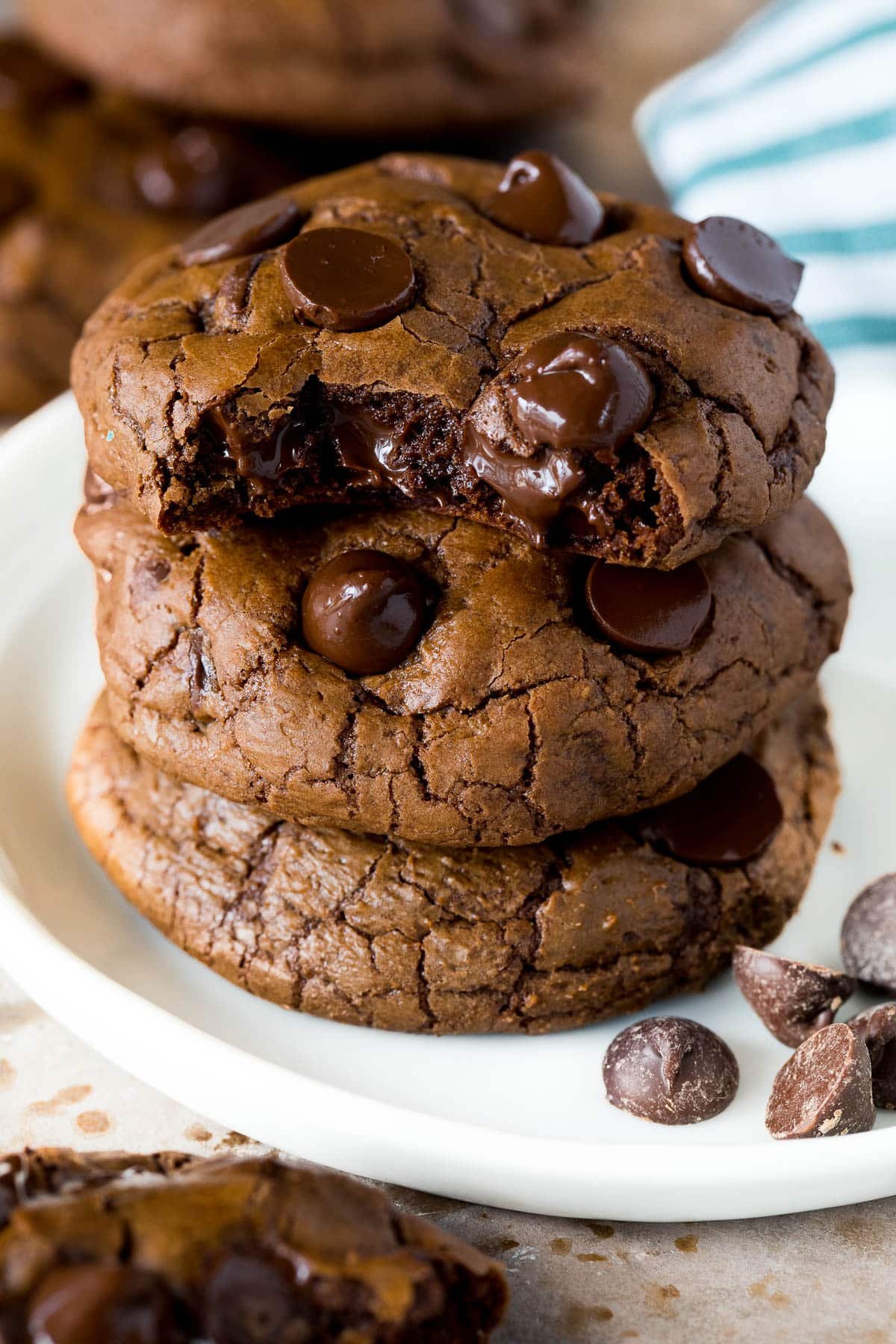 A stack of chocolate fudge cookies on a plate.