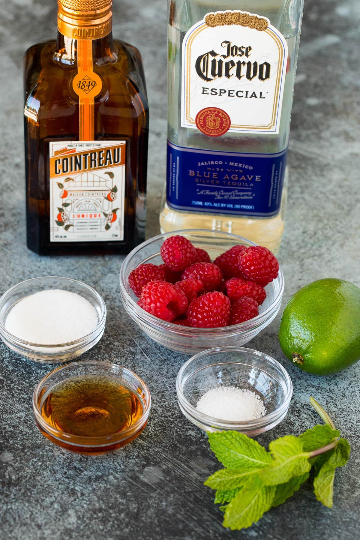Ingredients including salt, sugar, agave syrup, raspberries, limes and tequila.