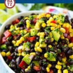 A bowl of black bean and corn salad topped with fresh cilantro.