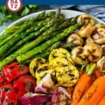 A plate of grilled vegetables marinated with a garlic and herb marinade.