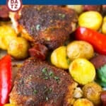 A sheet pan with Spanish chicken, potatoes and sausage.