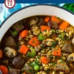 A pot of beef barley soup with seared beef stew meat, veggies and tender barley.