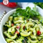 A bowl of Asian cucumber salad with sesame seeds sprinkled over the top.